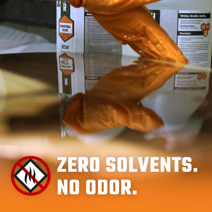 A closeup of a hand working with a 1.5 Gallon Kit Rock-Hard Epoxy Resin & Hardener.