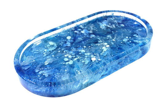 Because the resin is at its thinnest consistency right after pouring, the white ink easily pushes the blue and teal through, hitting the bottom of the mold with very little resistance creating this beautiful stringy pattern.